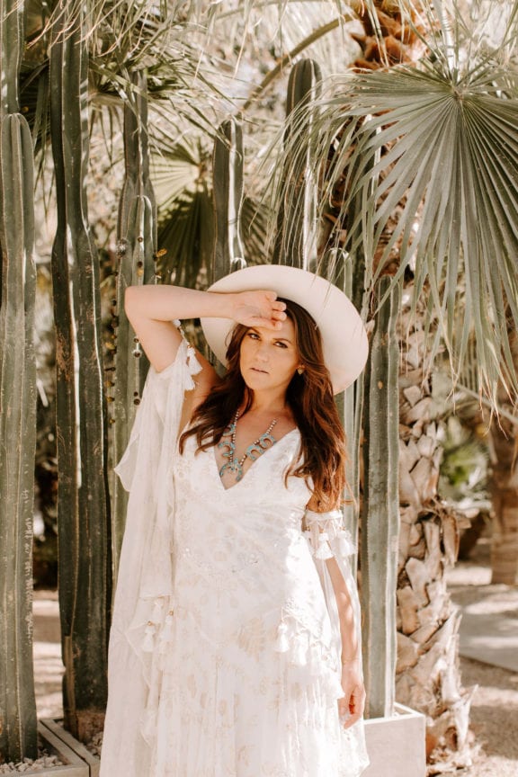 Rue de Seine Mira boho wedding dress with cowboy hat and squash blossom necklace
